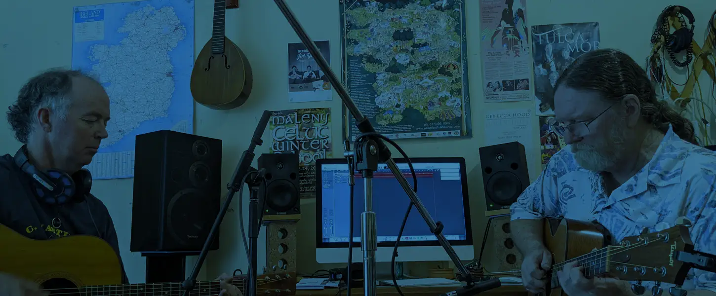 Two musicians playing guitar and recording a song