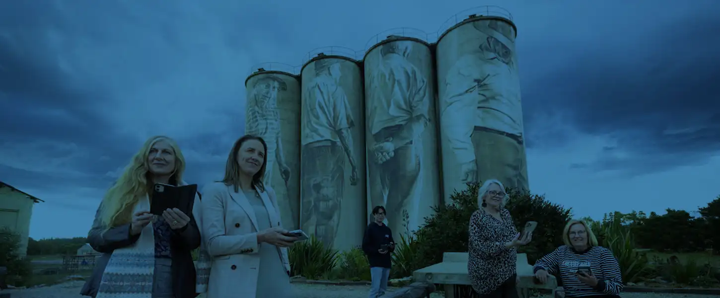 Portland cement silos and people on mobile phones experiencing the Portland Soundtrail