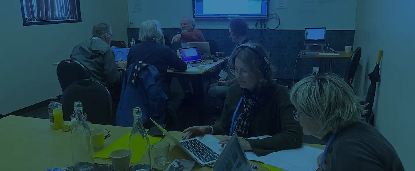 Class =room with adults on laptops